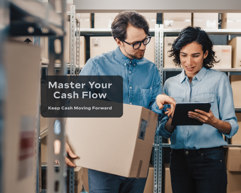 Two business professionals review inventory and logistics information in a warehouse while discussing operations and cash flow management.