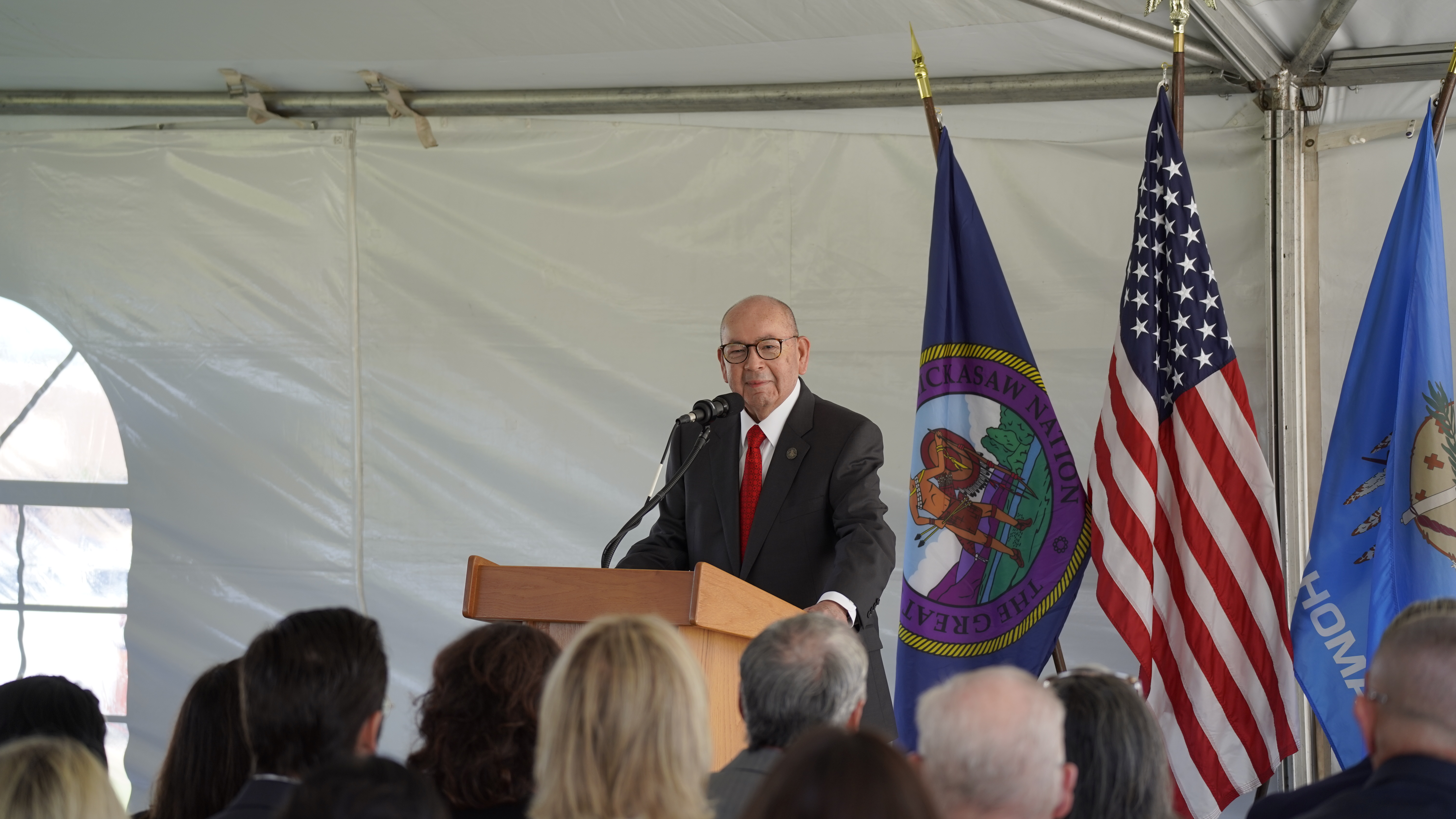 Governor Bill Anoatubby speaking a a podium during a Chickasaw Community Bank event.