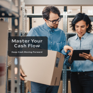 Two business professionals review inventory and logistics information in a warehouse while discussing operations and cash flow management.