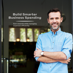 Small business owner standing outside while learning about business credit card benefits, rewards, and expense management tools.